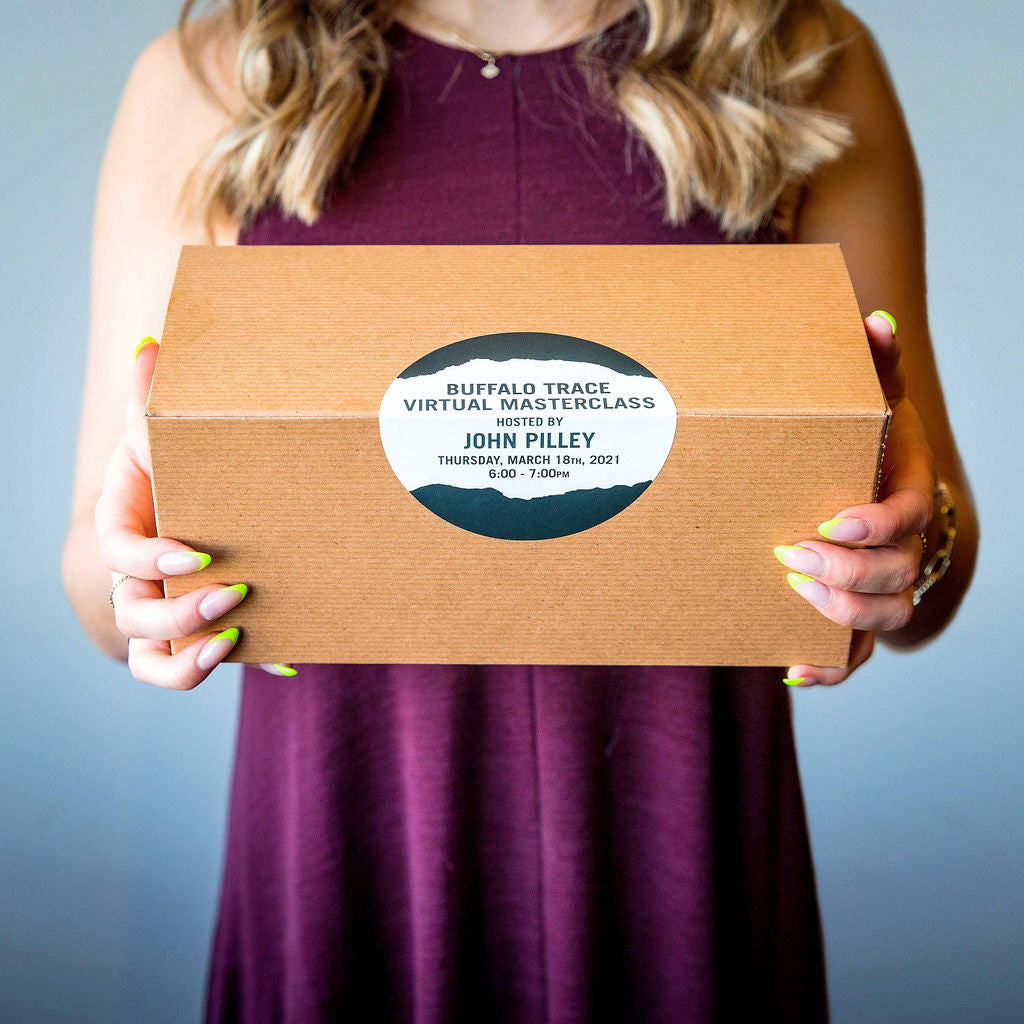 A girl holds a box of Buffalo Trace bourbon