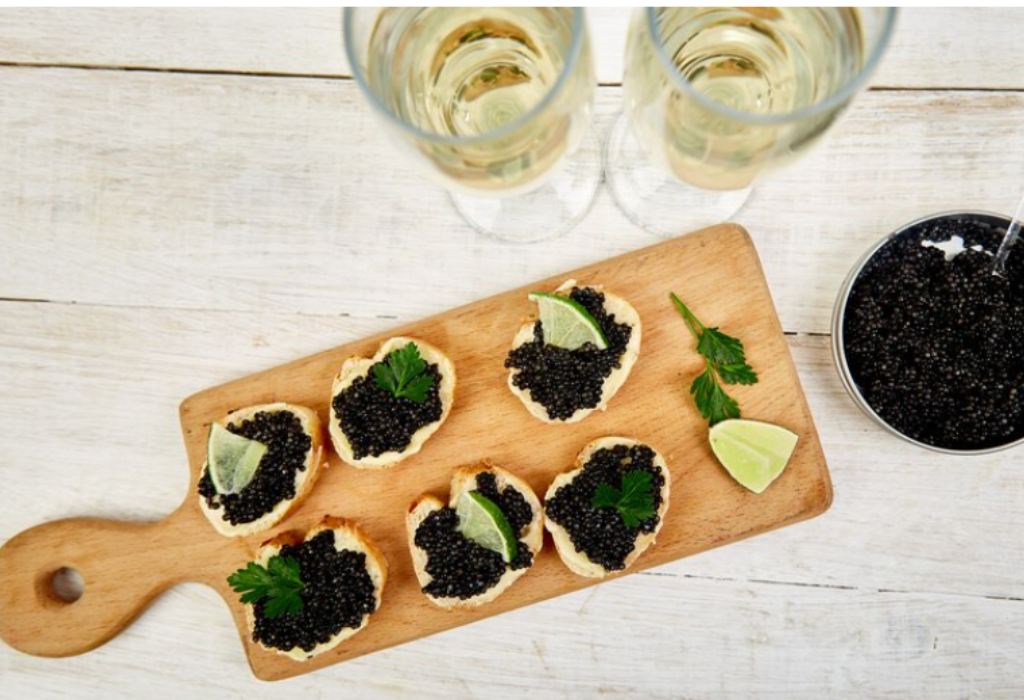 Caviar canapés displayed on a wooden cutting board