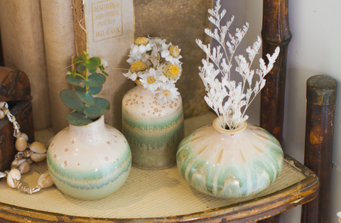 Three Small Vases On A Shelf