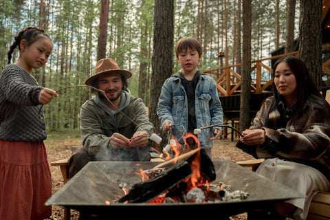 family toasting marshmallows campfire