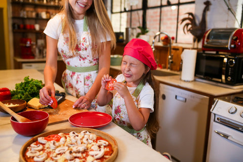 kid making pizza with mom
