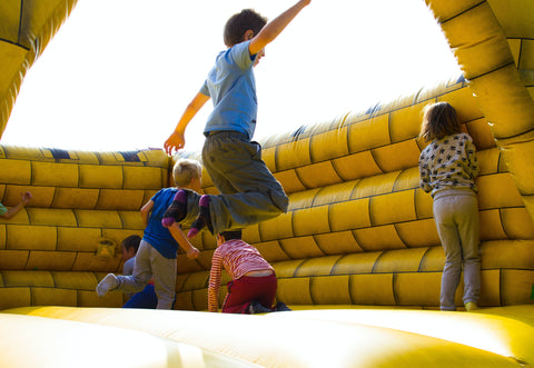 kids playing in inflatable castle