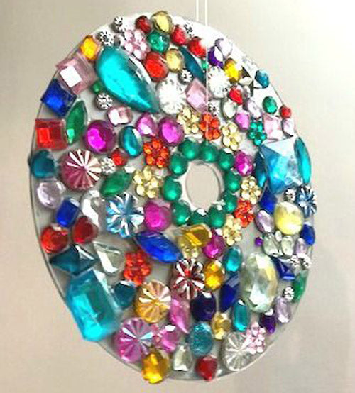 dazzling suncatcher made with multicolored gems glued to a CD