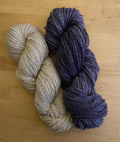 two skeins of yarn - one is natural and one is hand dyed