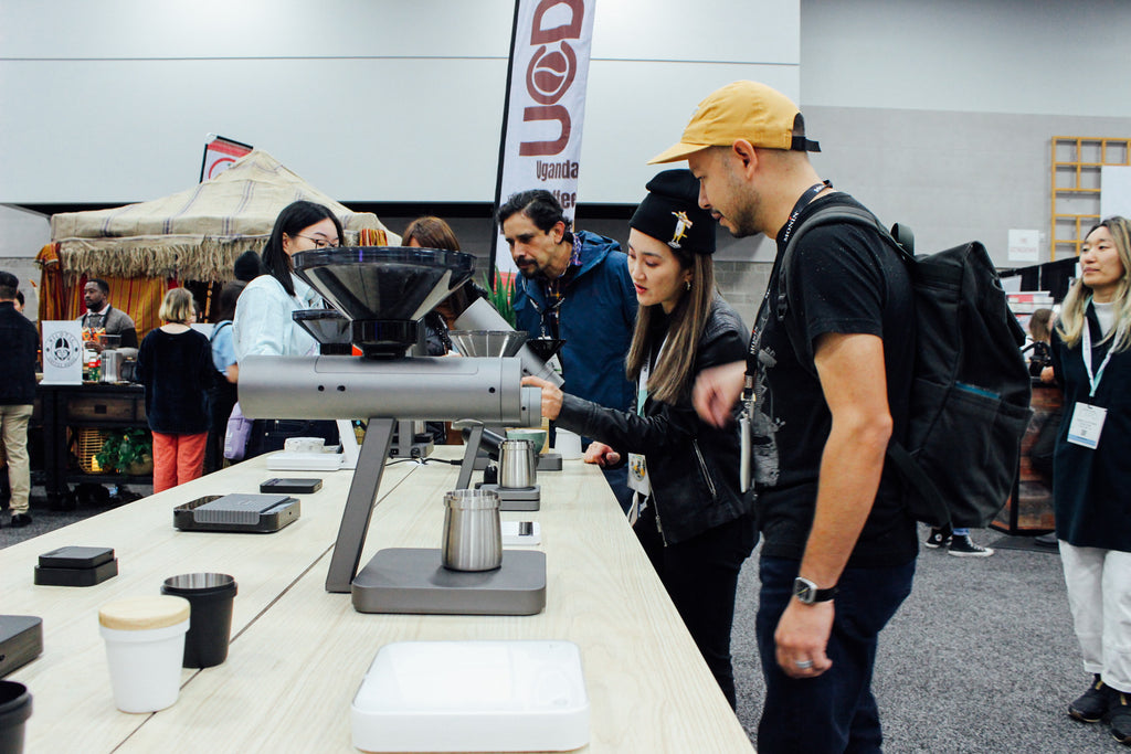 Acaia team member showing an Expo attendee the Orion