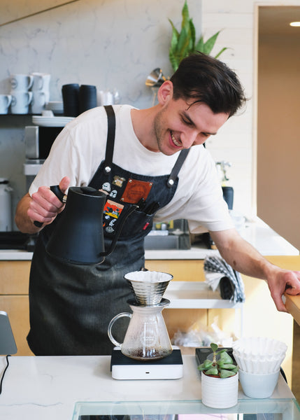 Olympia barista Nathan brewing coffee on a Pearl scale