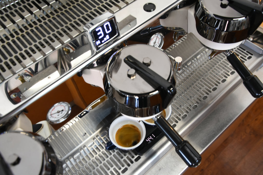 Lunar scale weighing espresso shots on a coffee machine