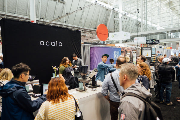 SCA Expo attendees standing around the Acaia booth