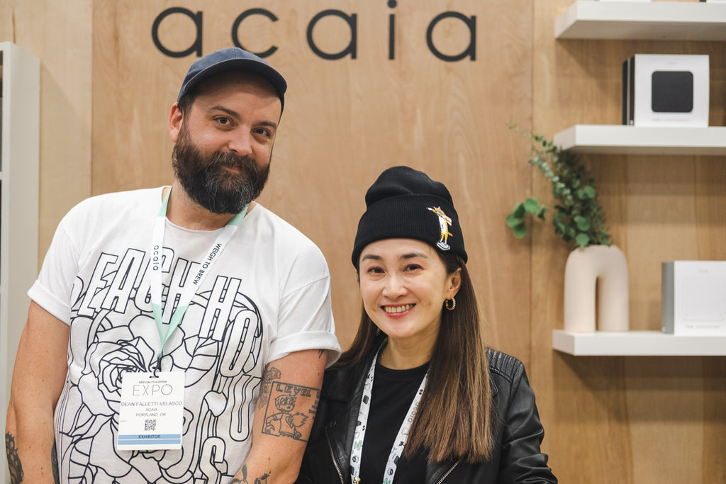 Two staff member smiling in the Acaia SCA Expo booth