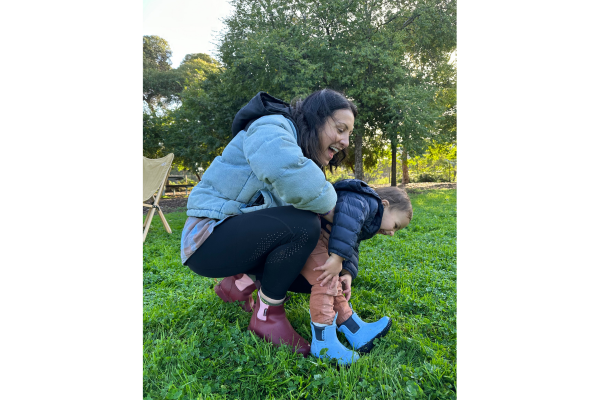 Dani and her son playing in a field together