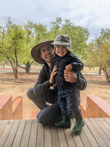 Dad and son posing with Merry People gumboots