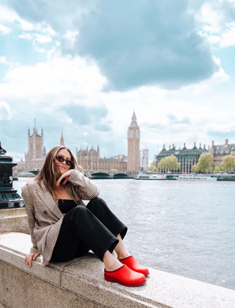 Ashley wearing red clogs in front of the big ben
