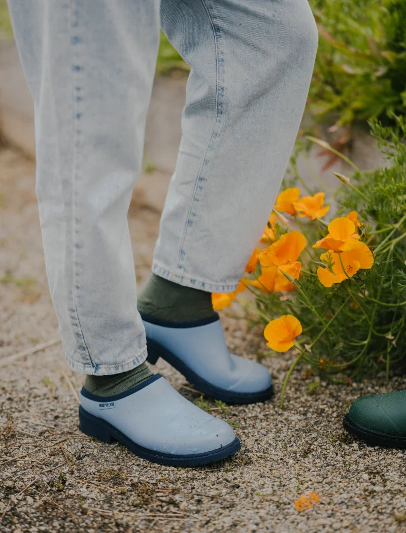 blue clogs and socks in the garden