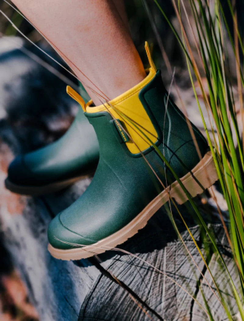 green boots on a log