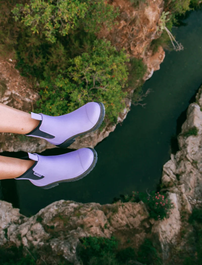 lavender boots over a river
