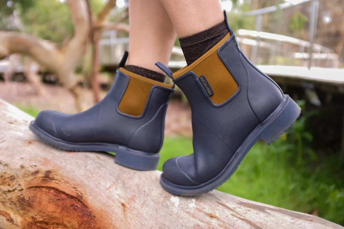 oxford blue boots on wooden log