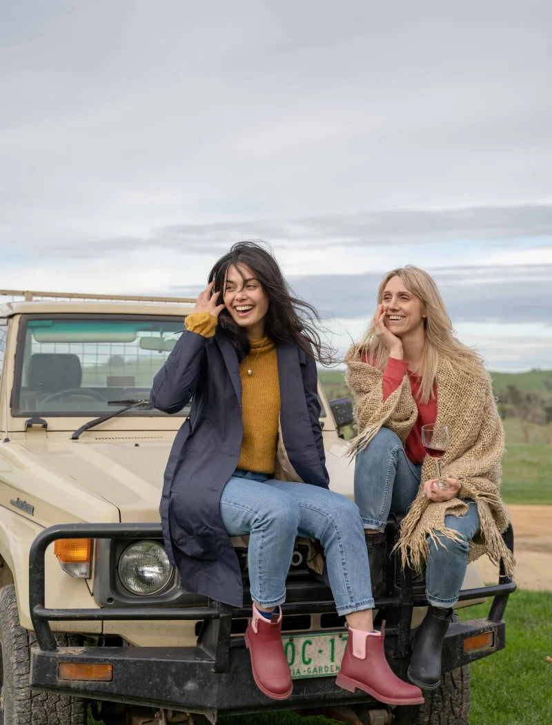 people sitting on a car wearing merry boots