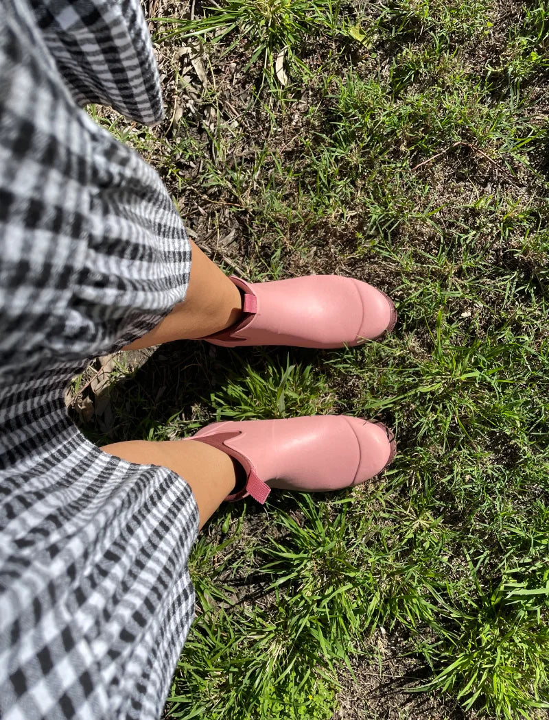 pink boots in the garden