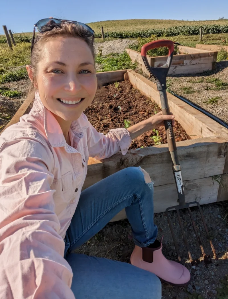 shovel in the garden wearing dusty pink boots