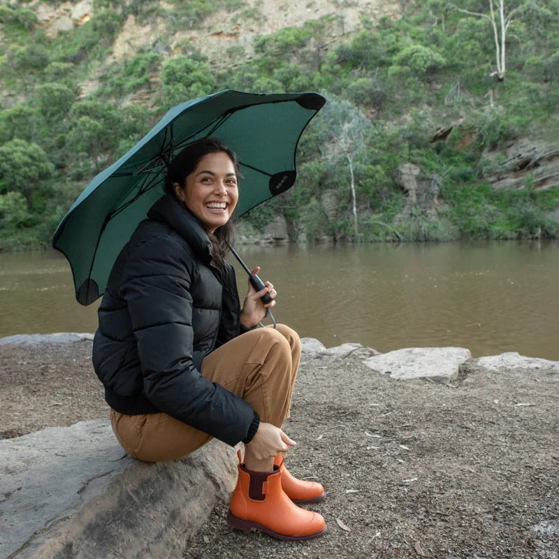 umbrellas and orange boots beside the lake