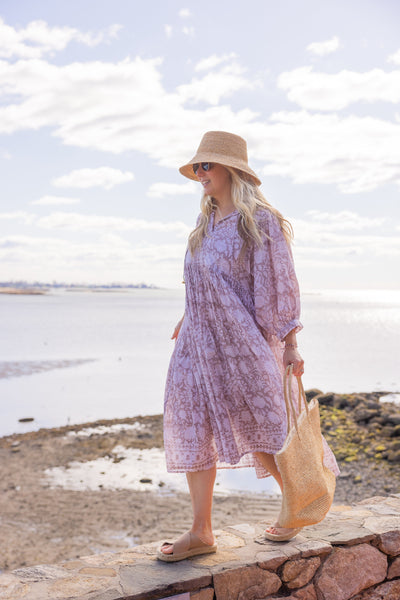 Raffia Bucket Hat on model at beach with beach bag