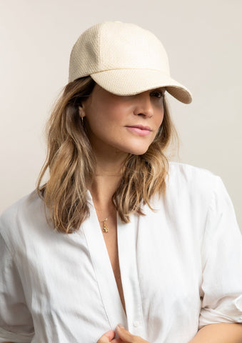 Woman with white baseball cap.