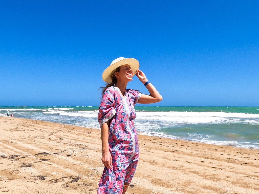 Woman on the beach wearing panama hat.
