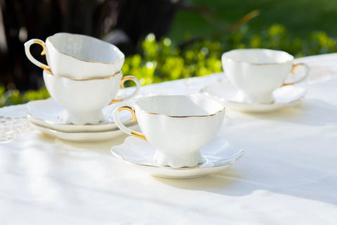 white and gold teacups