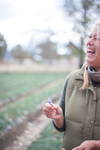 Melinda delights in picking a saffron flower