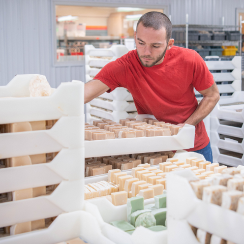 Colter stacking curing trays of goat milk soap