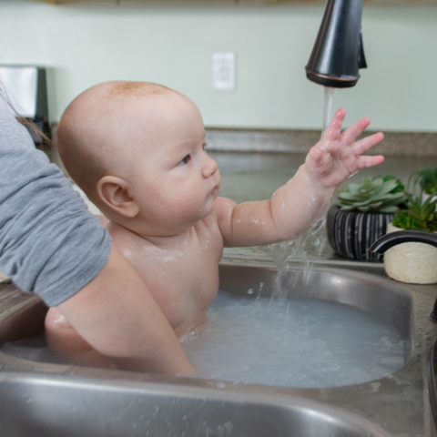 Michael in sink with goat milk bath soap shreds