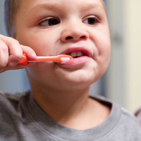 Landon brushing his teeth with Natural Tooth Powder