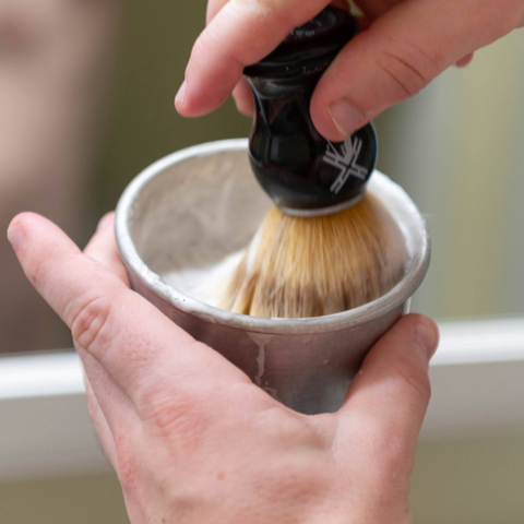 Lathering shaving soap with bowl and brush