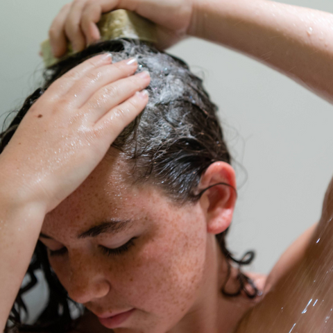 Indigo washing her hair with Goat Milk Soap Shampoo