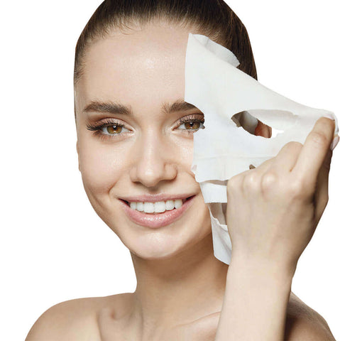 woman with smooth skin removing marine collagen sheet mask and smiling