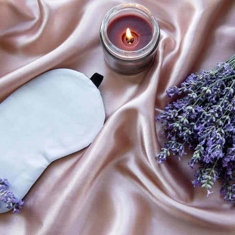 things that help you to sleep including silk eye mask lavender and a scented candle