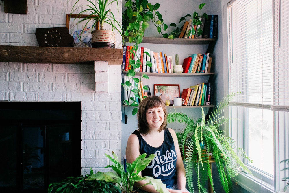 Andrea in her home with plants