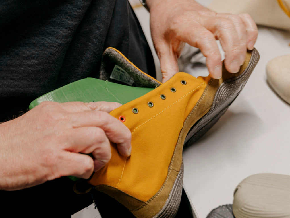 Close-up of a Wildling shoe held by two hands.