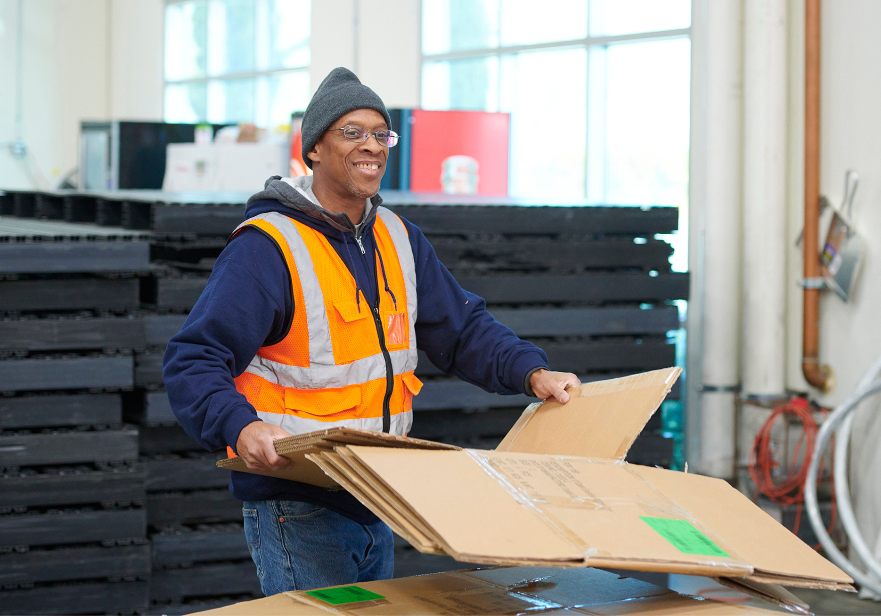 man recycling cardboard showcasing sustainable practices at South Bay International