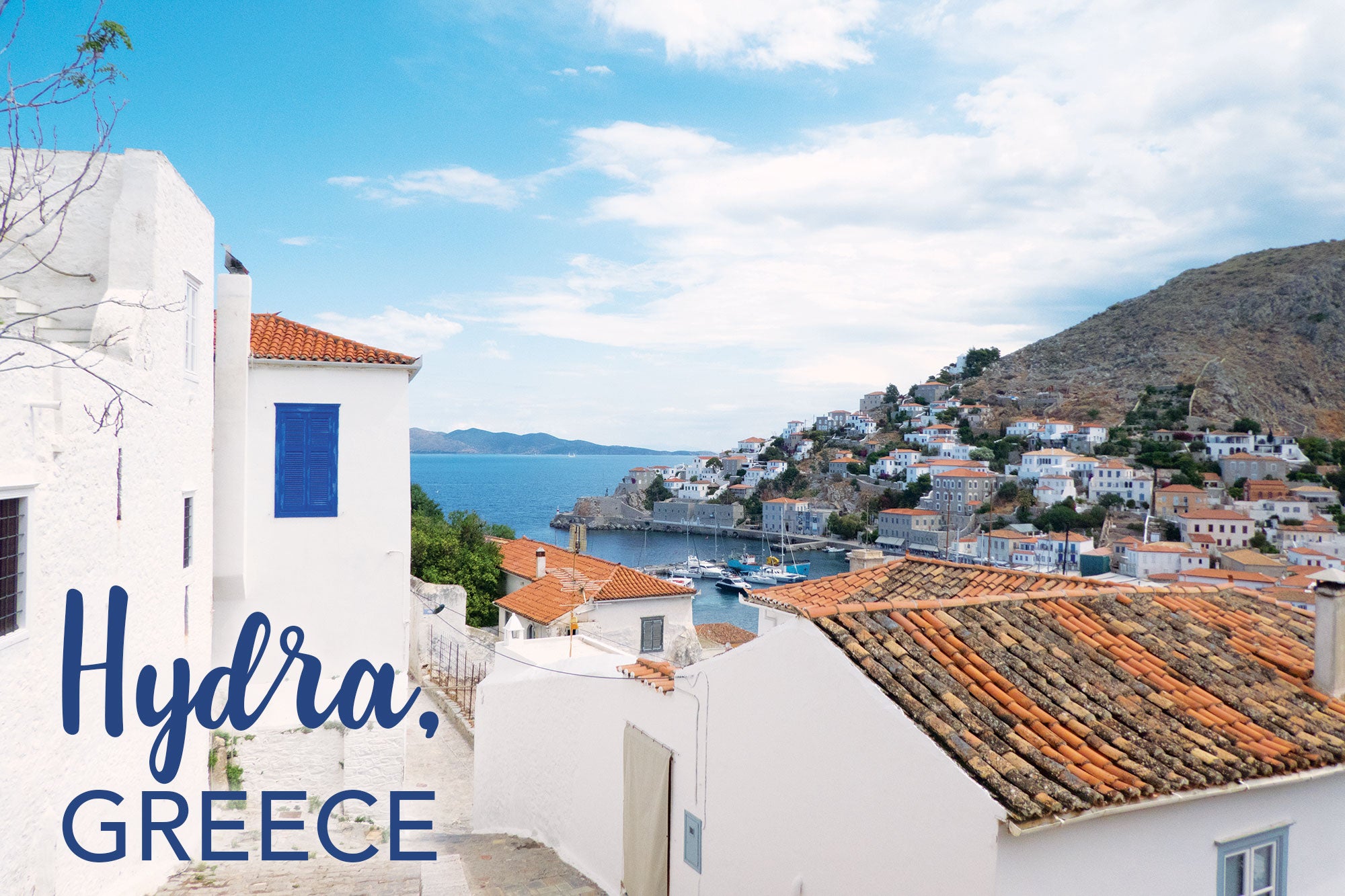 white houses overlooking the beautiful port of hydra, greece