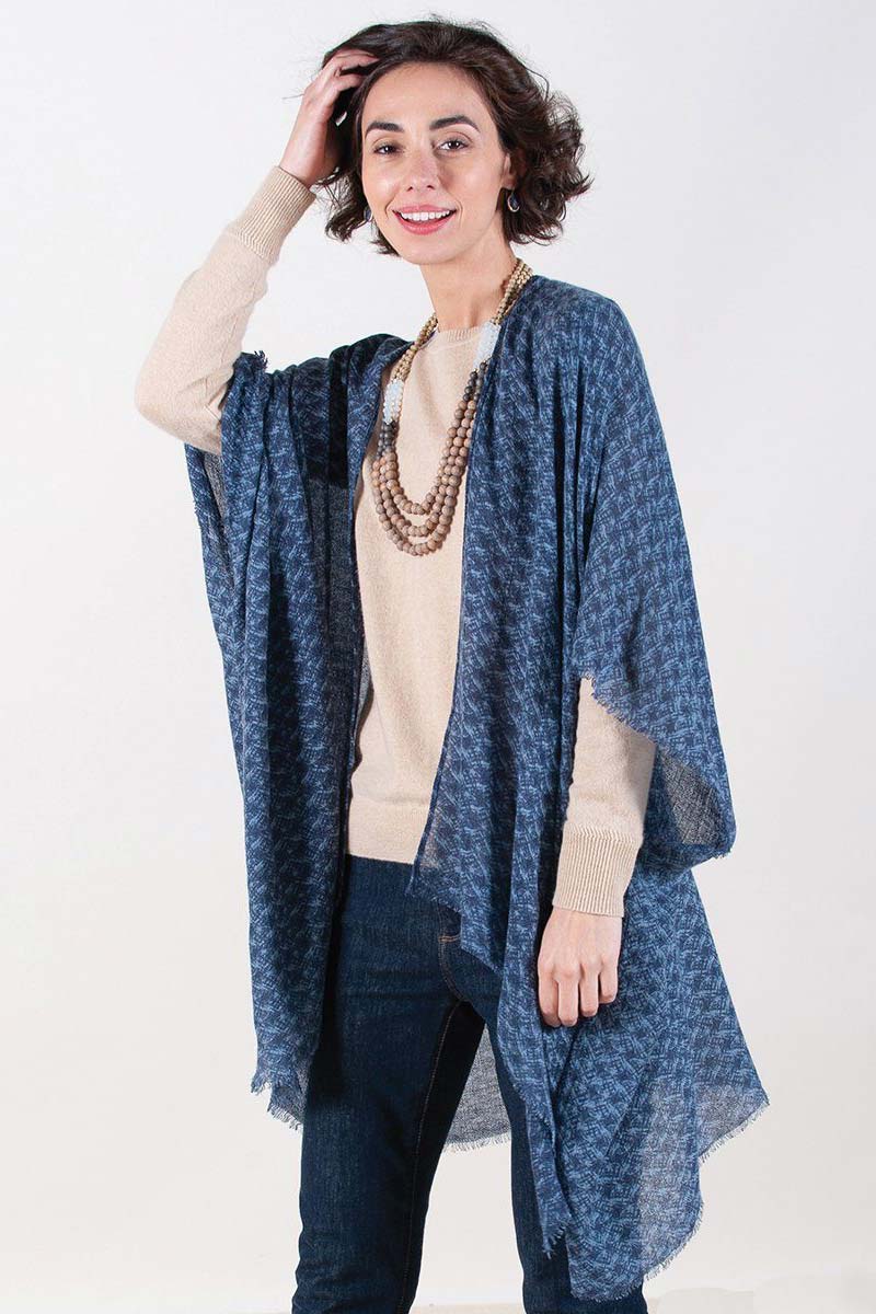 woman wearing blue printed fringe kimono with sweater and jeans