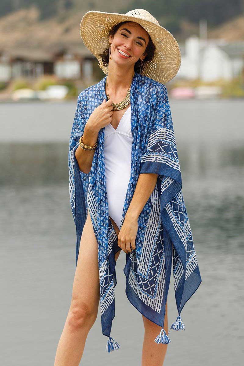 woman wearing navy blue kimono wrap over a white bathingsuit