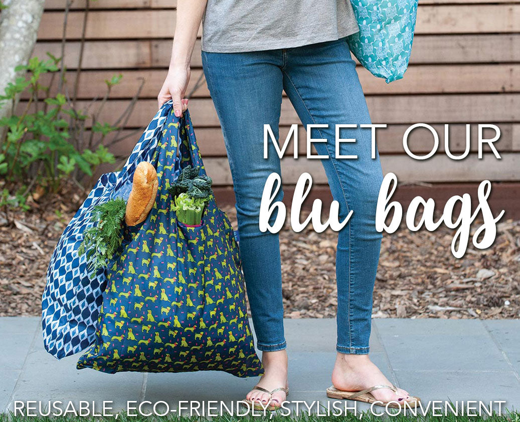 woman holding reusable blu bag shopping bags filled with groceries