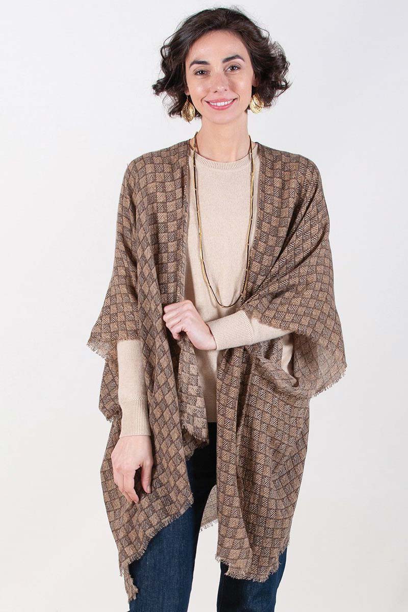 woman wearing brown printed fringe kimono with tan sweater and jeans