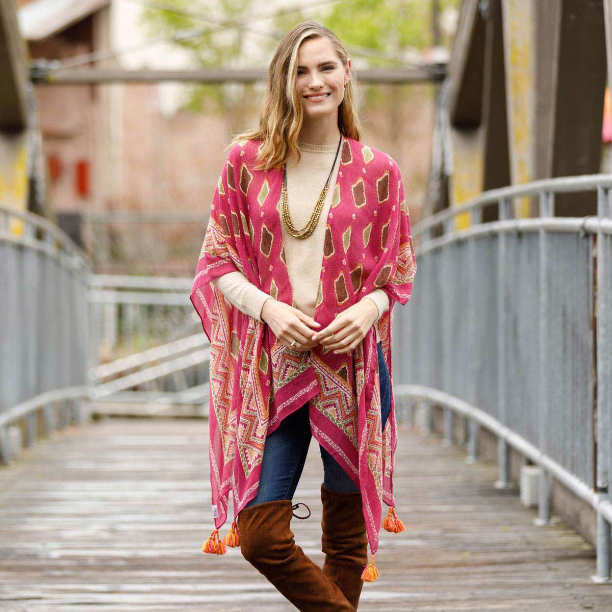 woman on a bridge wearing a pink kimono wrap inspired by morocco