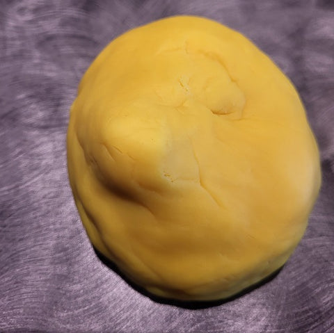 Image of playdoh that indicates a different shape than the previous image.