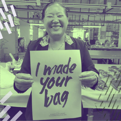 A woman with a glorious smile holds a sign that reads 'I made your bag'