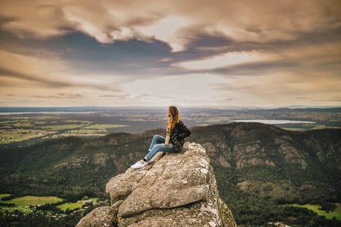 Taralynn Disher sitting on a cliff top