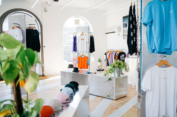 The interior of the Homie Store, with t shirts and caps in several colours.