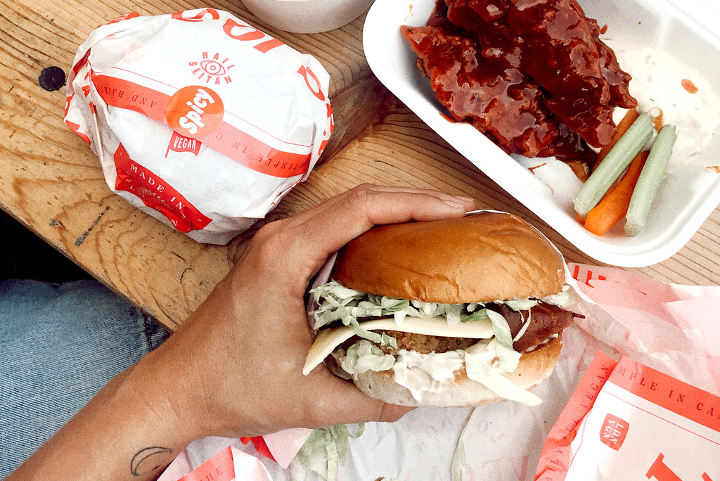 A vegan burger in closeup, held by hand